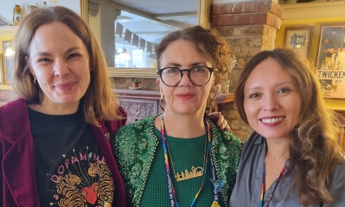 Three women smiling at the camera