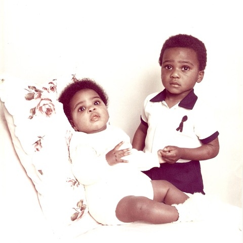 An old photo of a baby and her toddler brother